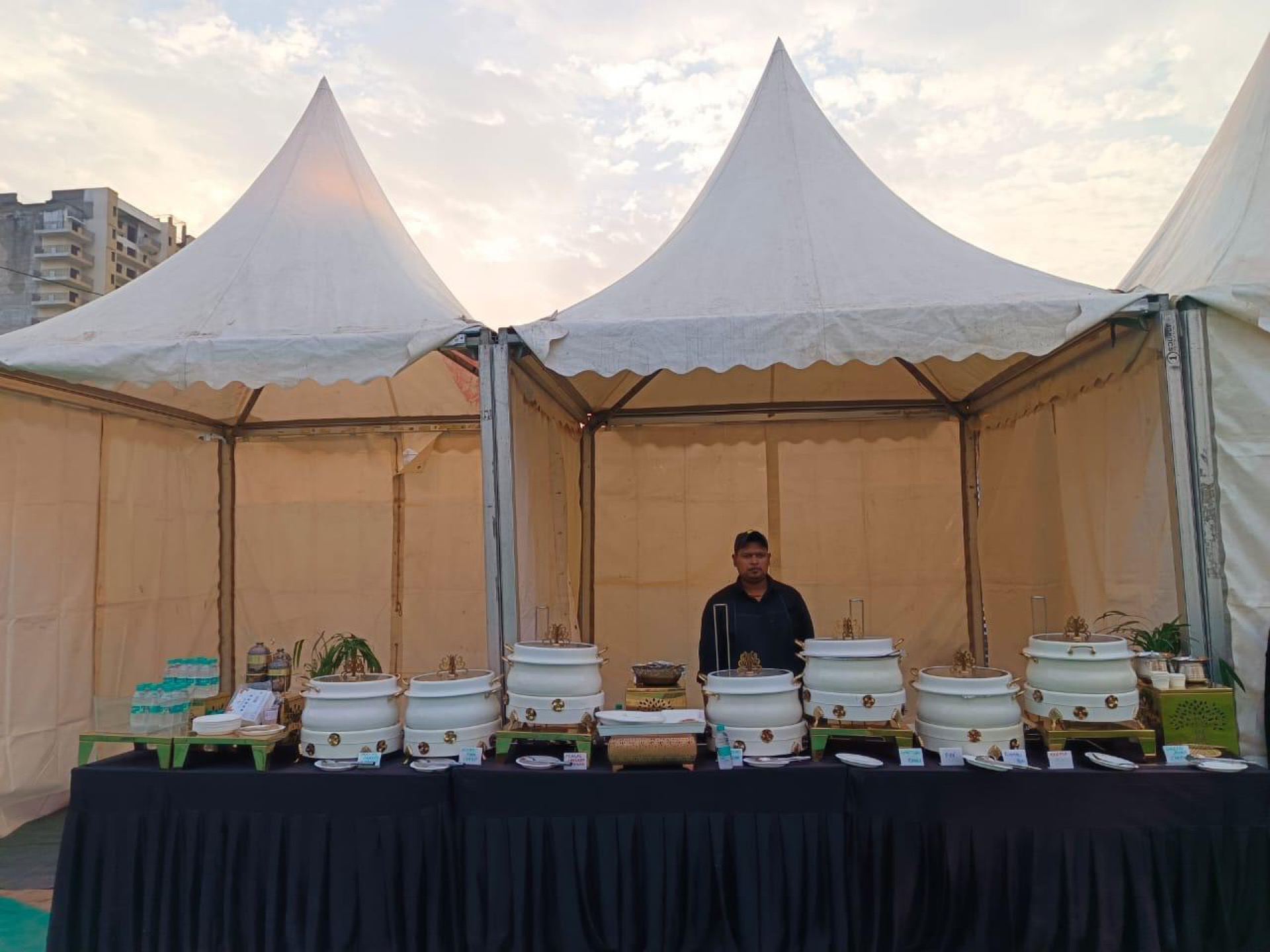 Outdoor corporate catering setup with elegant tent and buffet